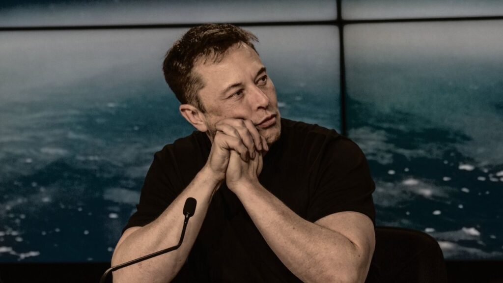 Elon Musk says the Twitter deal is temporarily on hold but adds that he is still committed